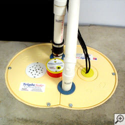 A sump pump system installed along a basement floor in Hamilton.