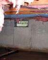Ontario crawl space with vents, showing mold, rot, and fiberglass insulation dripping off the ceiling.