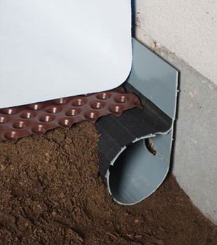Closeup of a crawl space drainage system installed in Elmira