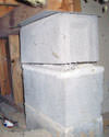 Concrete crawl space support posts in Ancaster that are showing signs of failure as they sink into the earth.