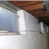 A foundation showing severe inward buckling along the windows in a Dundas home.