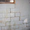 A cracked foundation wall near a window in a Paris home
