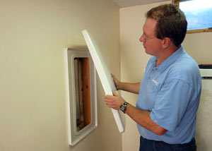 Foundation wall anchor covers installed in a finished basement with a repaired foundation wall in Elmira.