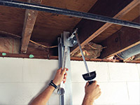 Straightening a foundation wall with the PowerBrace™ i-beam system in a Milton home.