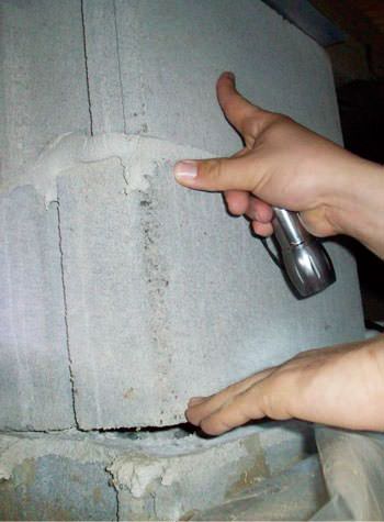 a completely failing concrete crawl space support pillar in Acton