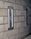 an inside view of foundation wall anchors installed along a basement wall to brace and repair the structure in Georgetown