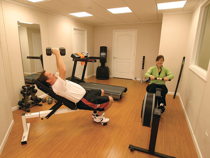 Wood Laminate Basement Floor Finishing Warranted Flooring A Basement Gym And Workout Room With Wood Laminate Flooring Installed In St Catharines