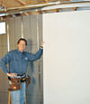Installing wall panels on top of our basement wall insulation in Cambridge